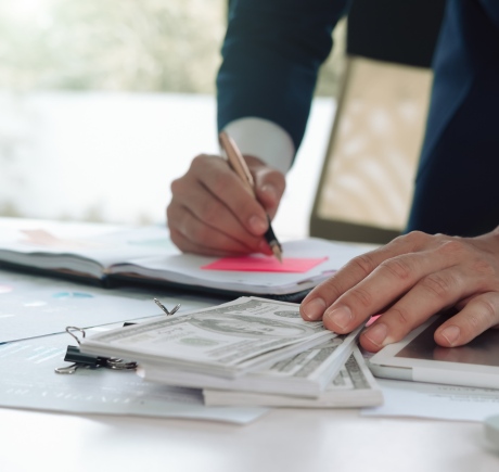 Income based valuation assessment with financial documents and cash on the desk in a modern office setting Income based valuation